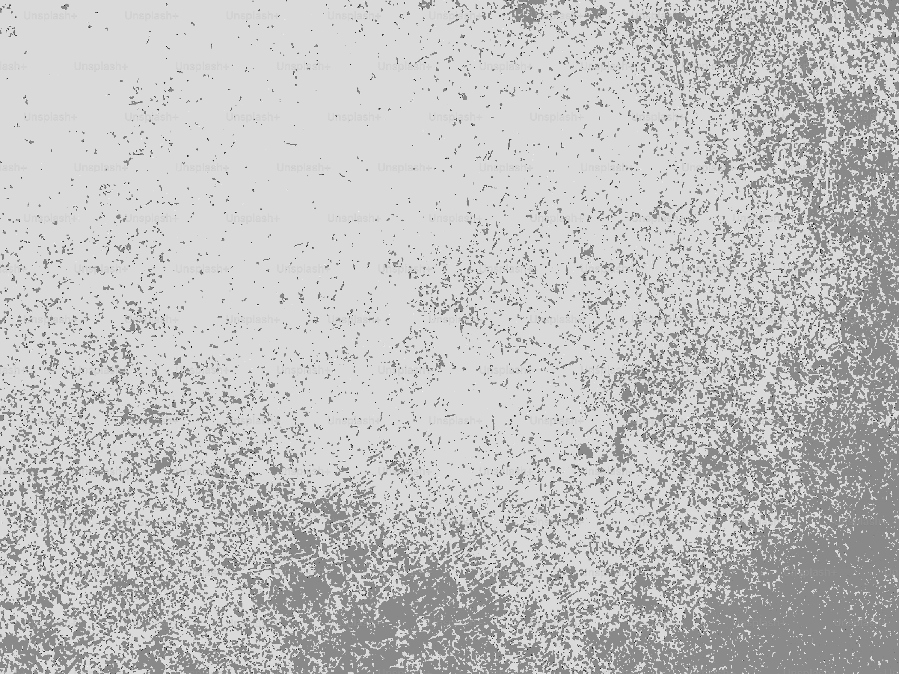 Ein strukturierter grauer Hintergrund mit helleren und dunkleren Bereichen.