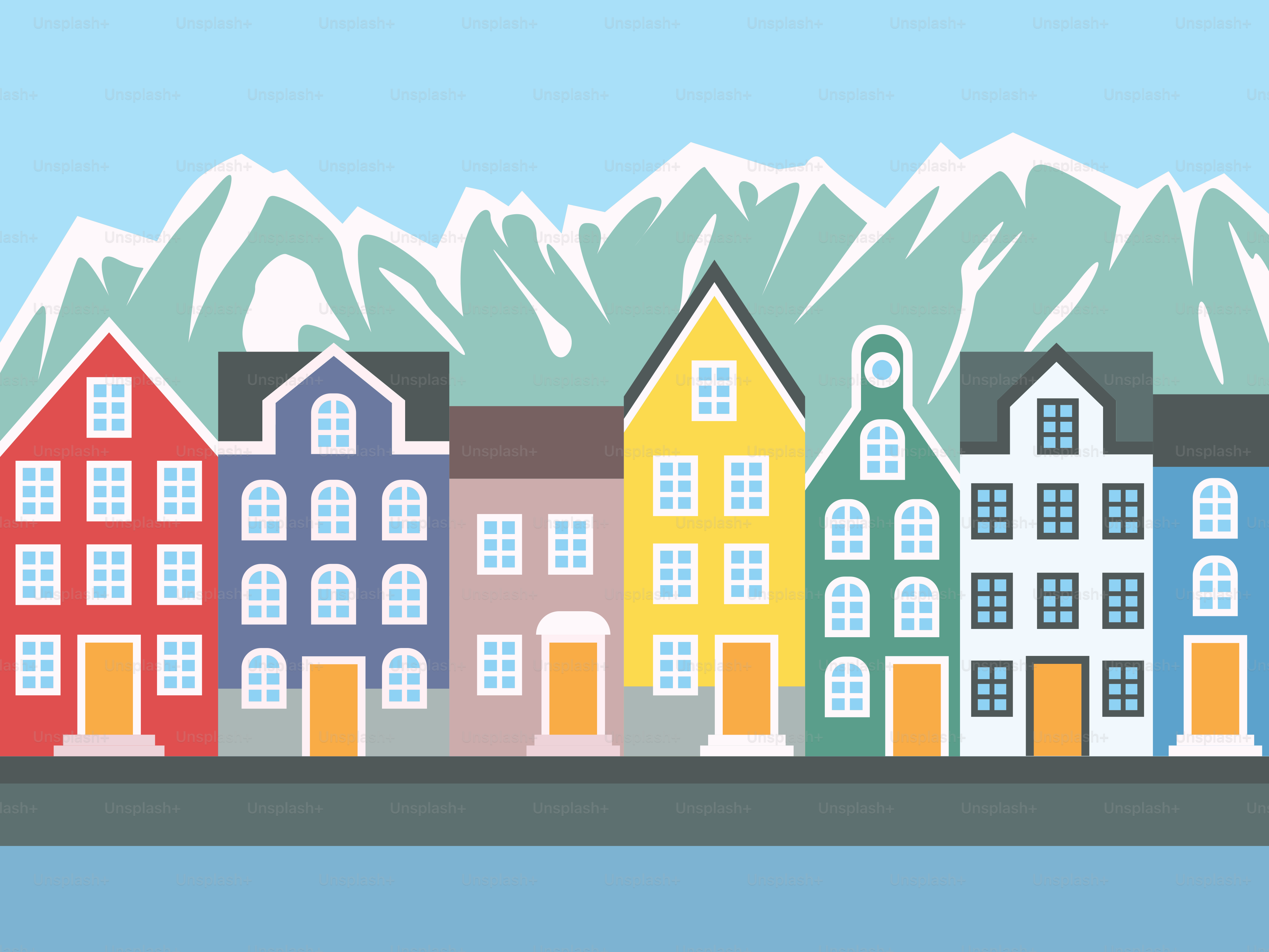 Bunte Gebäude vor schneebedeckten Bergen.