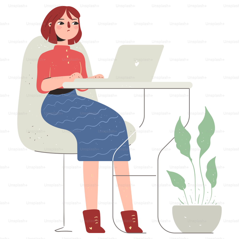 Woman sitting at a desk working on a laptop.