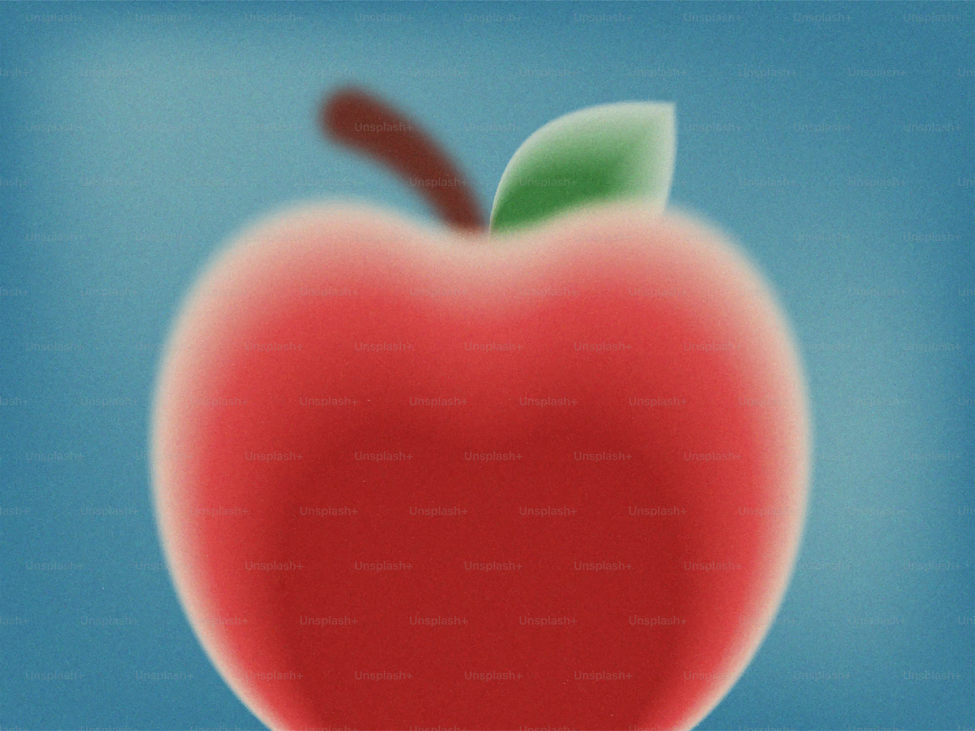 A red apple with a green leaf