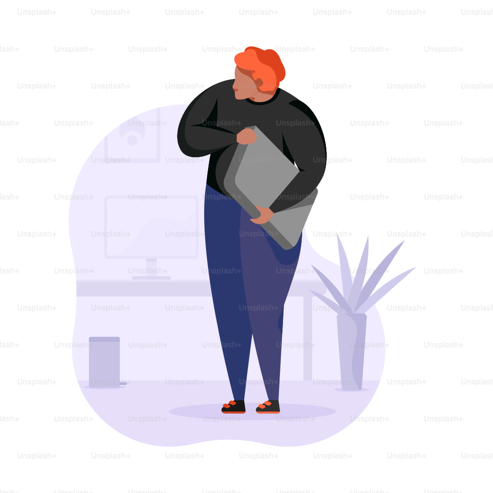 Person holding a laptop in an office setting.