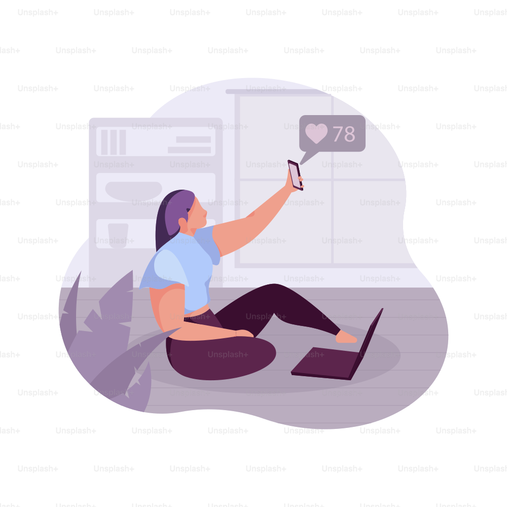 Woman taking a selfie with a laptop nearby