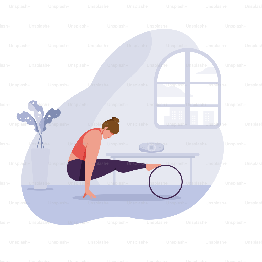 Woman practicing yoga with a wheel in a bright room.