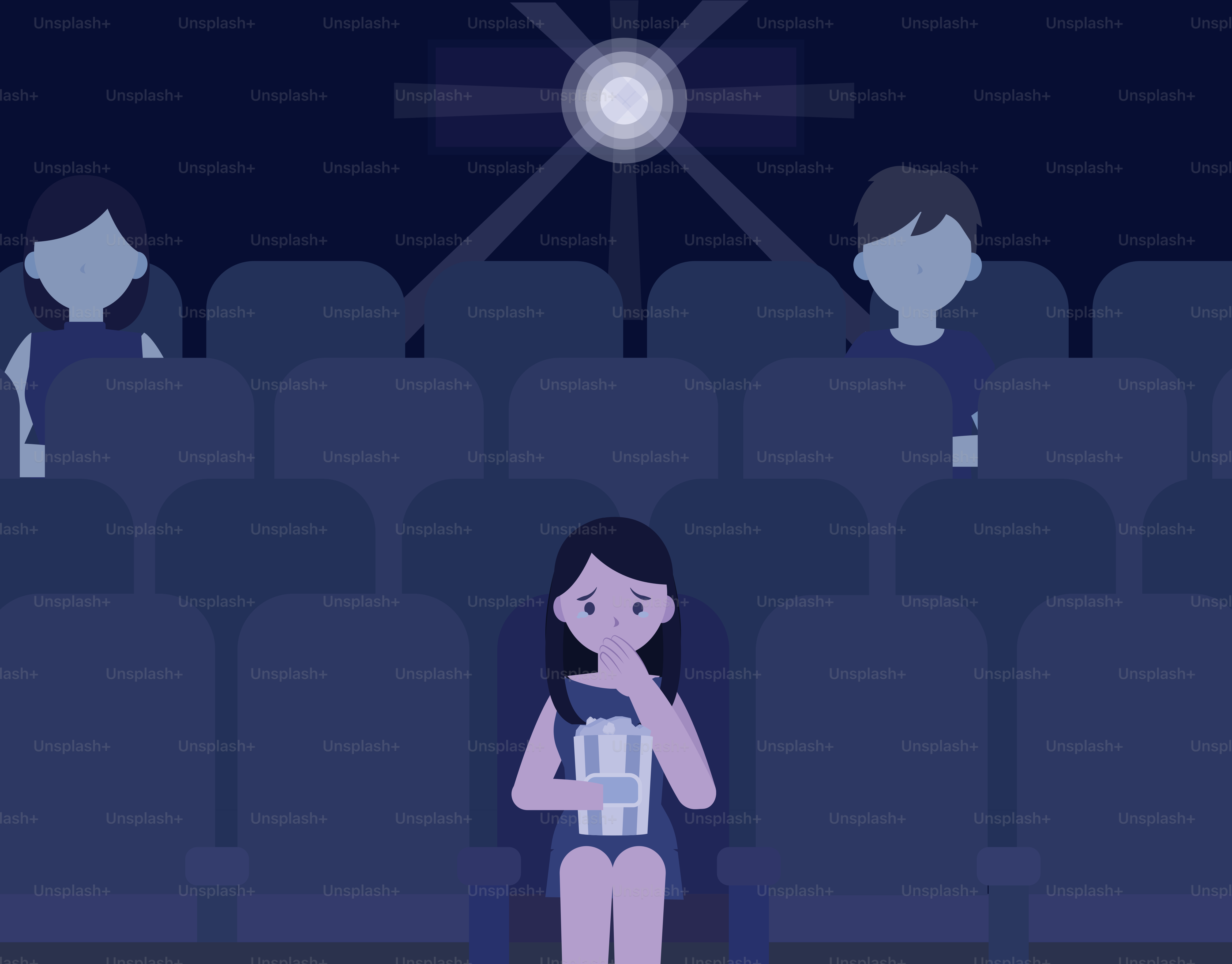 暗い劇場で映画を見ている人。
