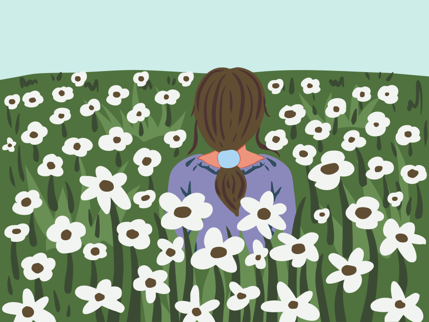 Une personne est allongée dans un champ de fleurs blanches.