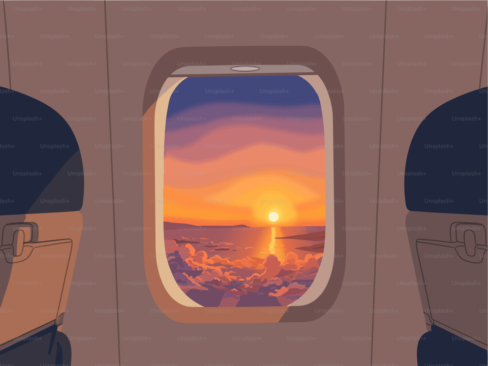 雲の上、飛行機の窓から見える美しい夕焼け。