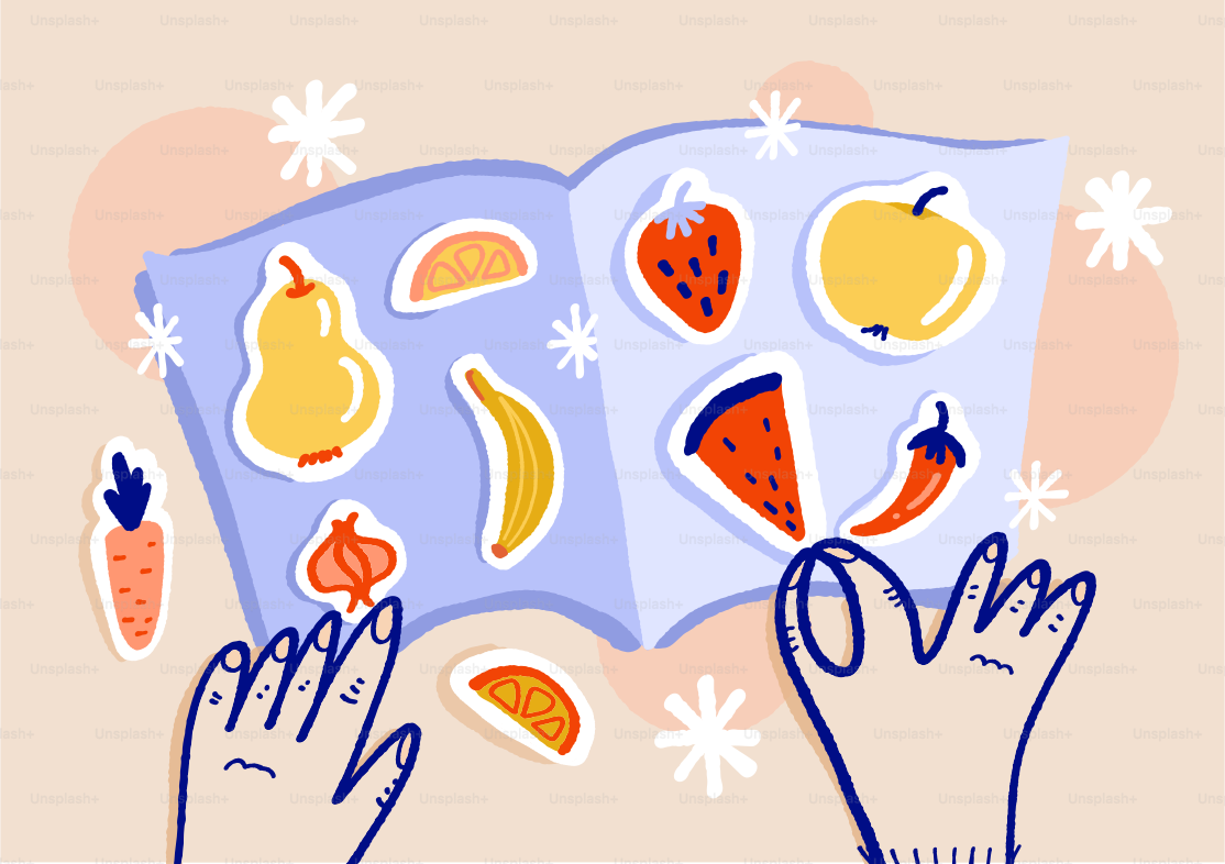 Hands placing colorful fruit and vegetable stickers into a book
