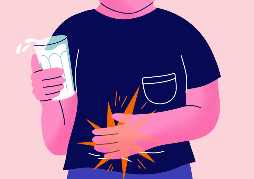 Person holds milk, experiencing stomach pain