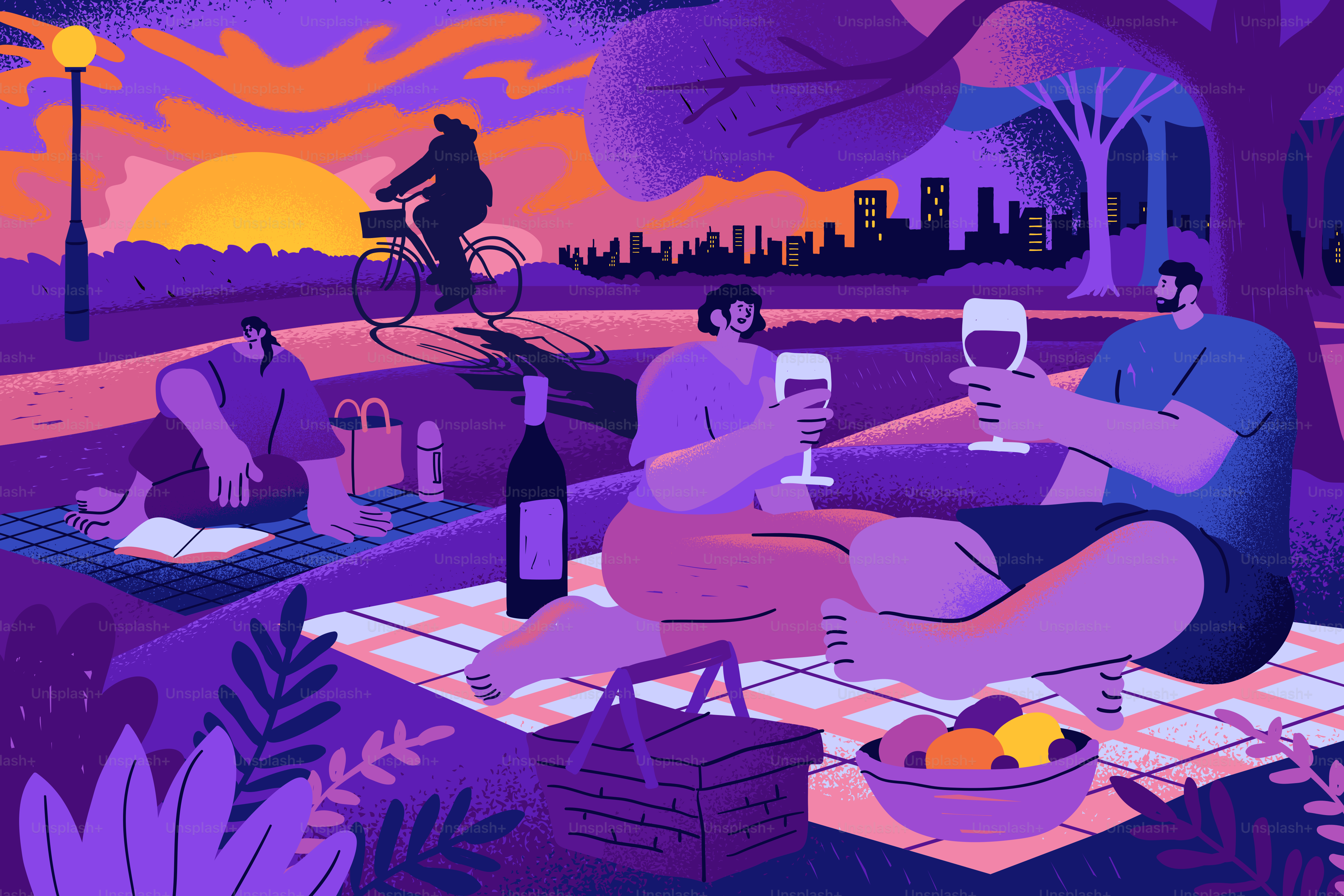 People having a picnic in a park with a city skyline at golden hour