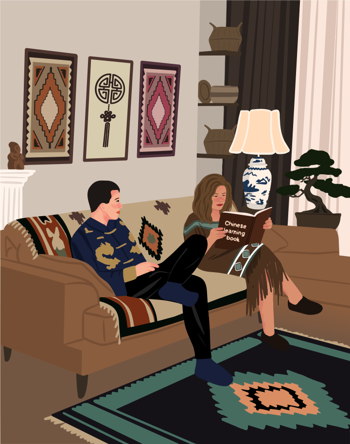 Two people sitting on a sofa in a living room reading a book
